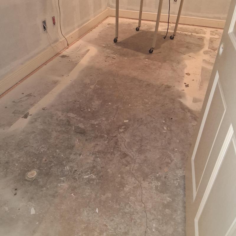 Concrete subfloor with cracks and debris prep work