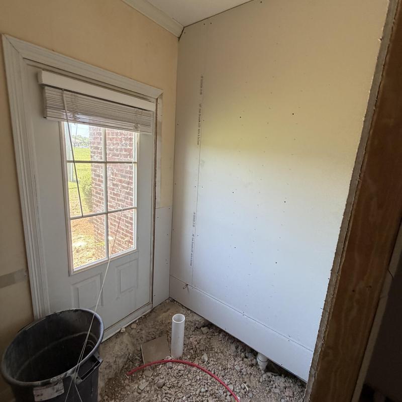 Sheetrock installation on interior wall near door