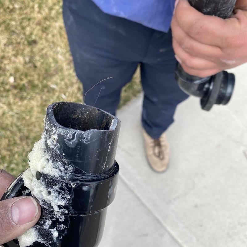 Tub overflow pipe with cracked fitting and residue buildup Tub overflow pipe with cracked fitting and residue buildup