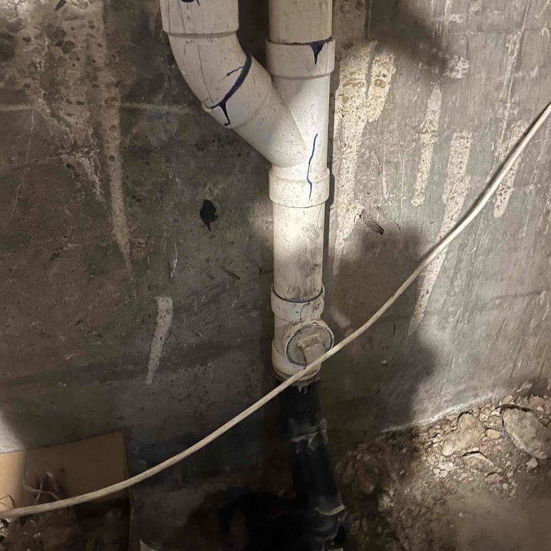Basement sewer pipe with cleanout and grease buildup