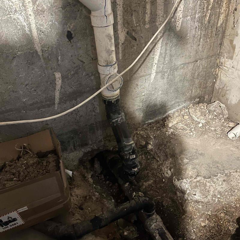 Basement sewer pipe excavation with grease buildup
