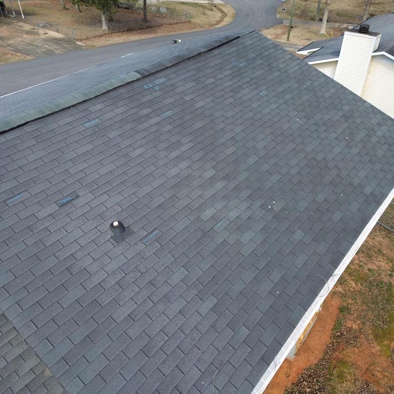 Asphalt shingle roof with clean ridge cap installation