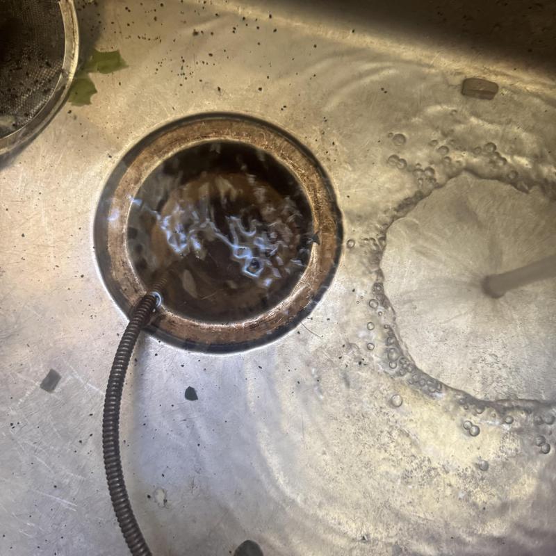 Kitchen sink drain cleared with hand crank cable machine Kitchen sink drain cleared with hand crank cable machine