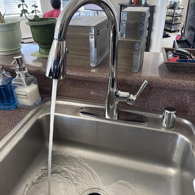 Kitchen faucet with running water in stainless sink Kitchen faucet with running water in stainless sink