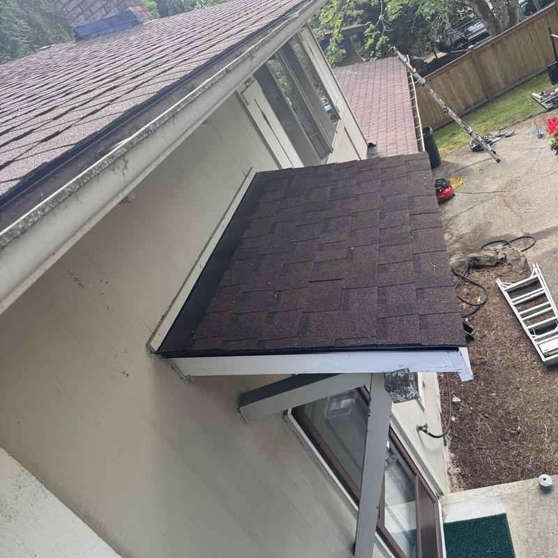 Shingle awning roof installation on house exterior