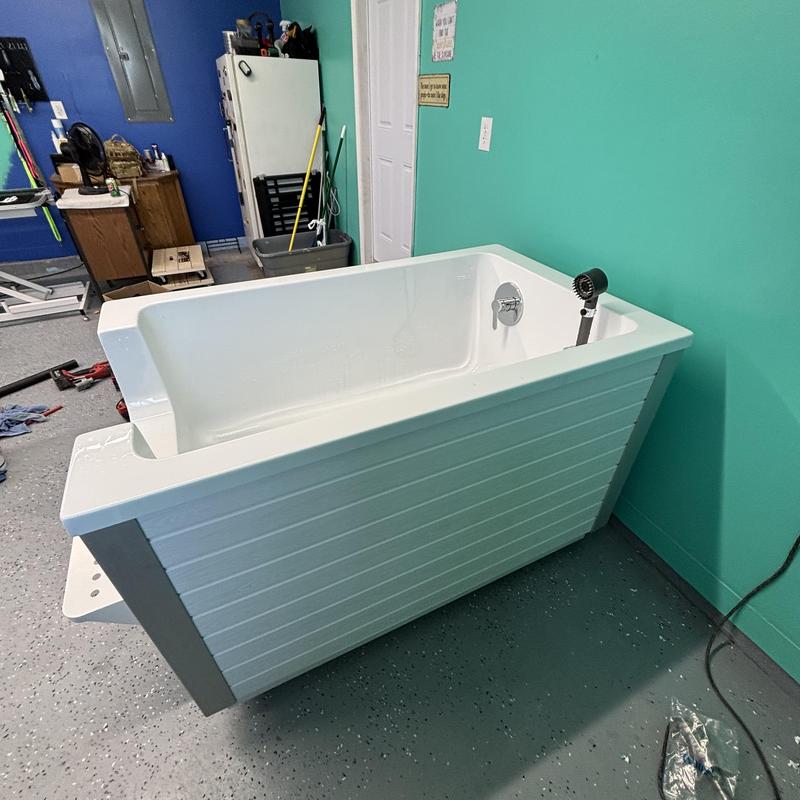 Dog wash station plumbing installation in room corner