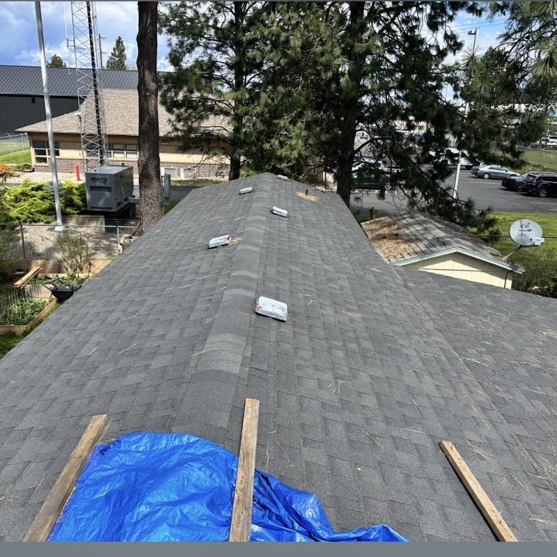 Asphalt shingle roof with ridge vents and tarp cover Asphalt shingle roof with ridge vents and tarp cover