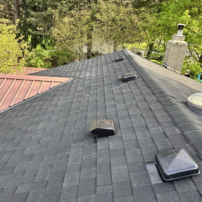 Asphalt shingle roof with ventilation vents and chimney Asphalt shingle roof with ventilation vents and chimney