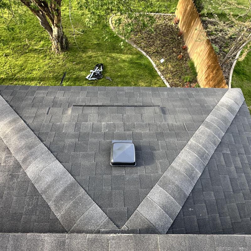 Asphalt shingle roof with ridge vent and roof vent installed Asphalt shingle roof with ridge vent and roof vent installed