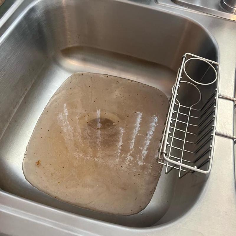 Kitchen sink with slow draining water and grime buildup