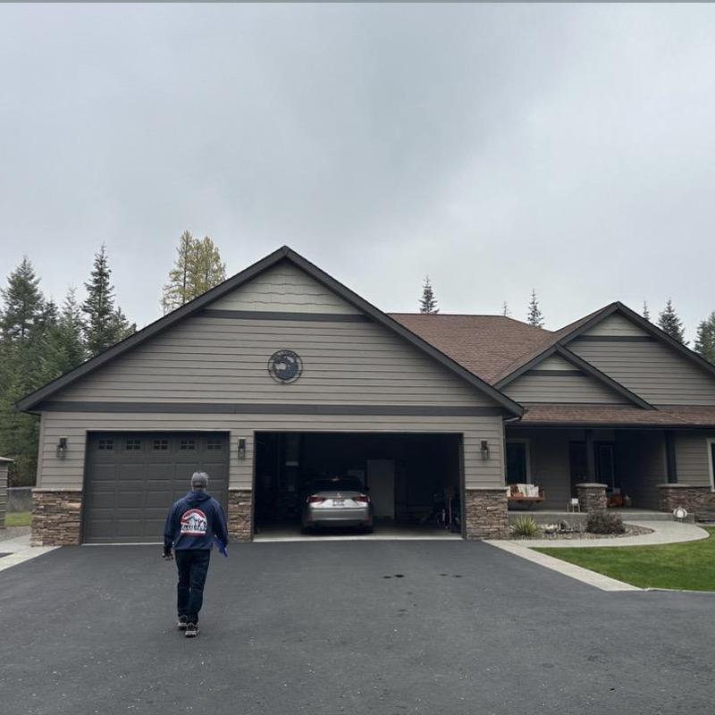 House siding inspection with attached garage and stone accents House siding inspection with attached garage and stone accents