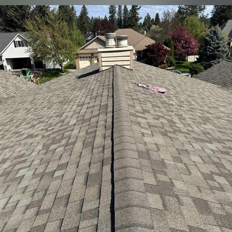 Ridge shingles replacement on asphalt roof ridge