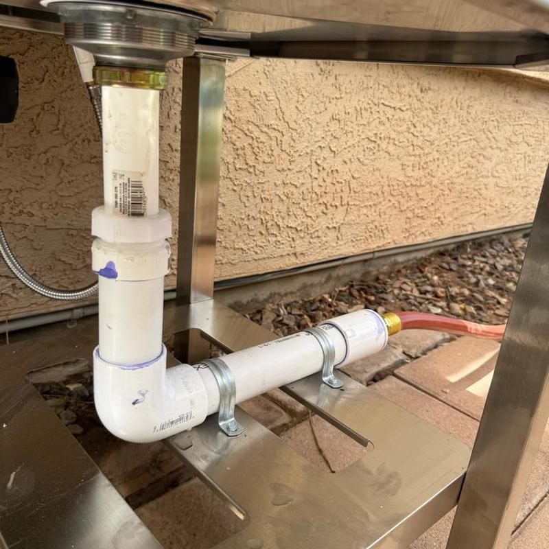 Utility sink PVC drain piping with hose connection