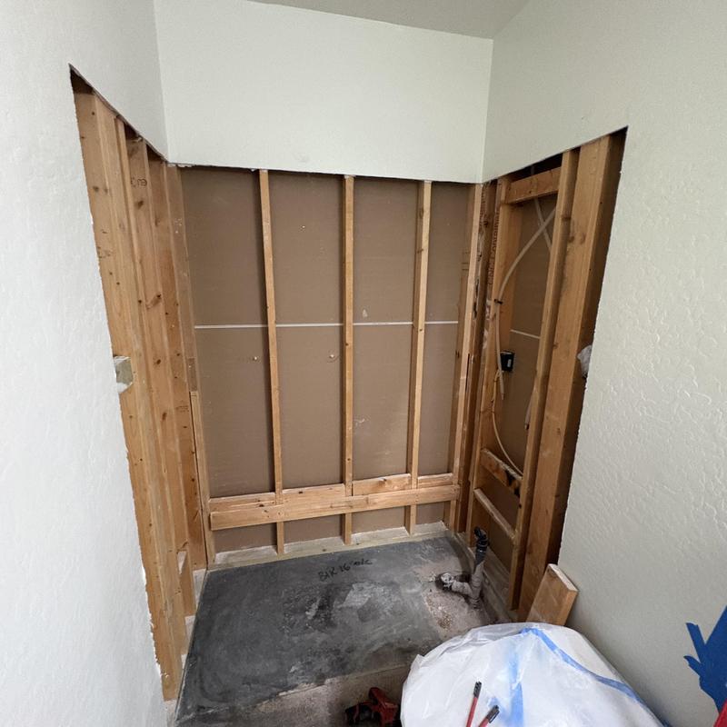 Shower demo with exposed framing and plumbing rough-in Shower demo with exposed framing and plumbing rough-in