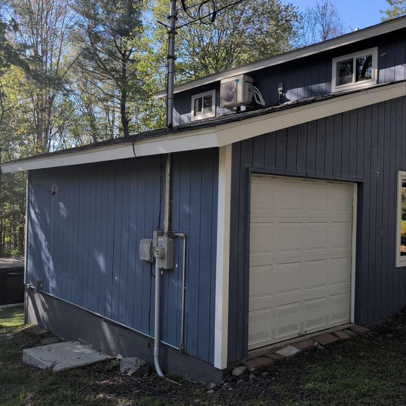 Garage door and exterior siding with electrical meter Garage door and exterior siding with electrical meter