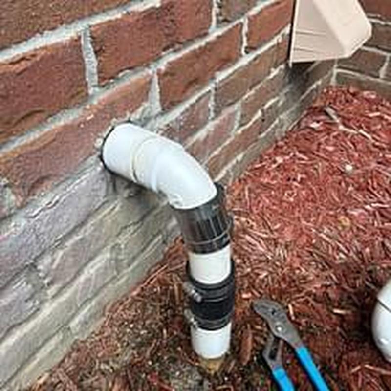 Sump pump discharge line reconnected outside home
