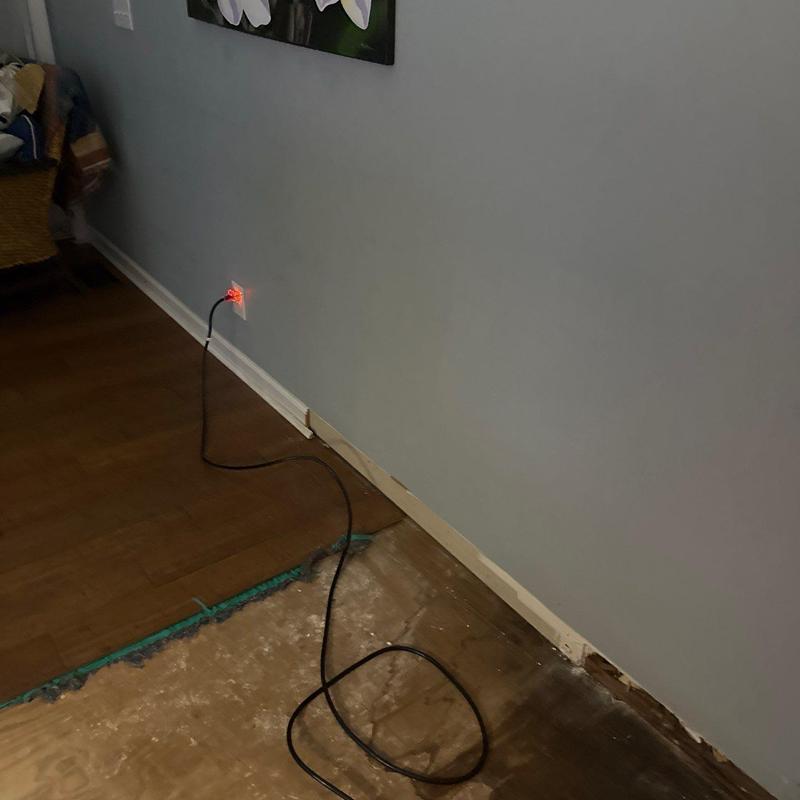Floor underlayment removal and exposed subfloor near wall
