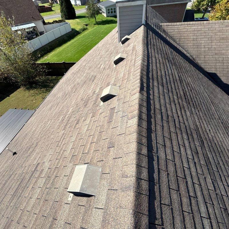Asphalt shingle roof with ventilation vents and ridge detail