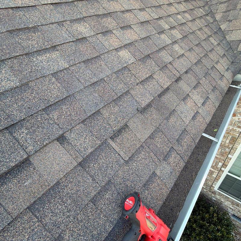 Asphalt roof shingles with hail damage and granule loss