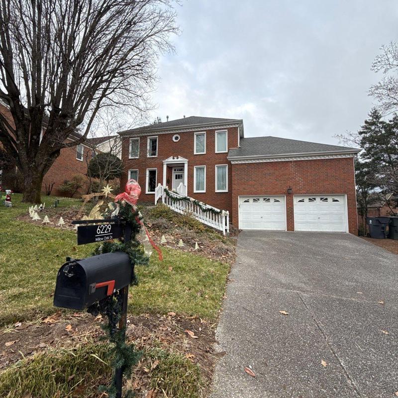 Mailbox with holiday decorations in front of brick home