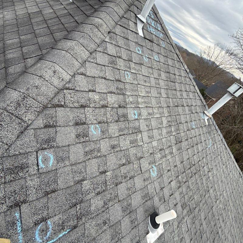 Asphalt shingle roof with hail damage inspection marks