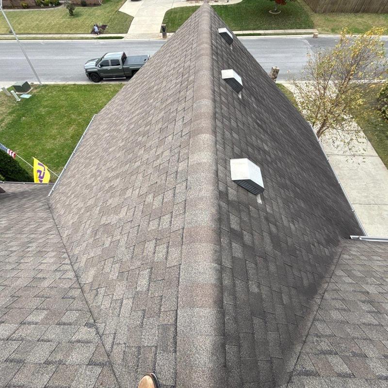 Roof shingles and ridge vent inspection on pitched roof