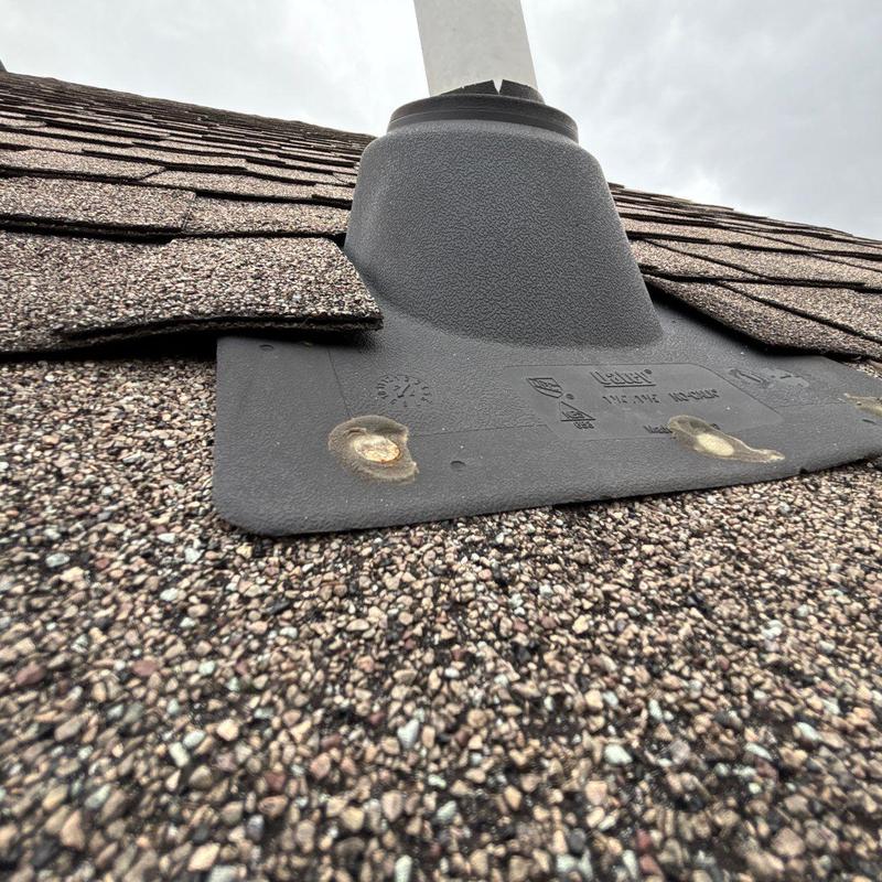 Roof pipe flashing with worn roof shingles and sealant damage