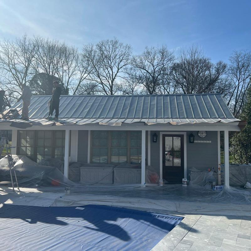Metal roofing installation on residential porch roof
