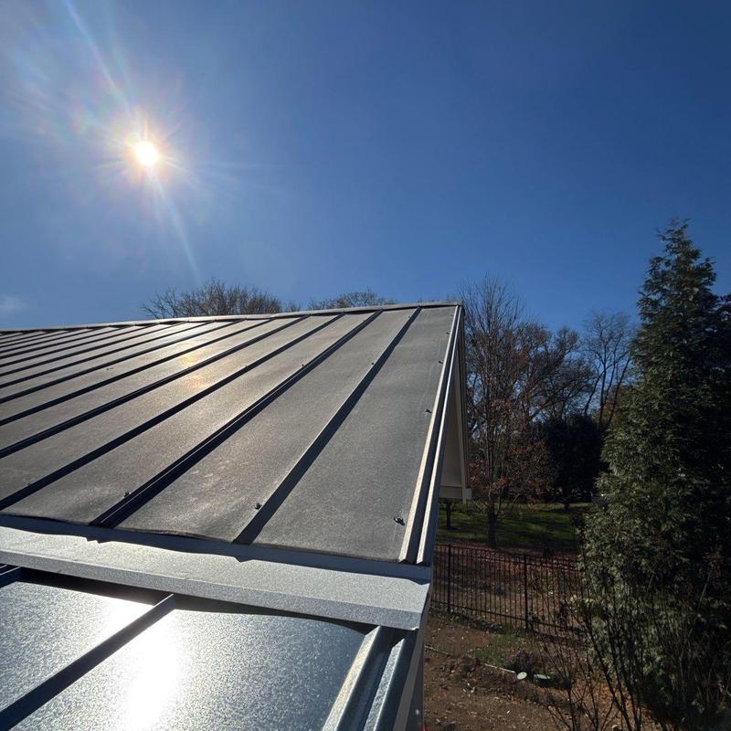 Metal standing seam roof panels under sunlight