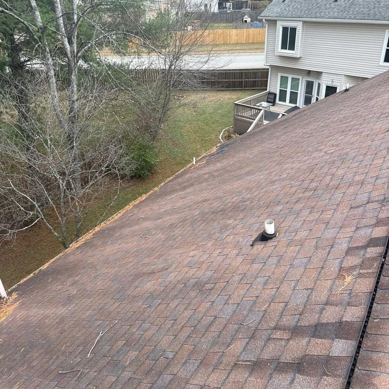 Roof shingles with hail damage and vent flashing