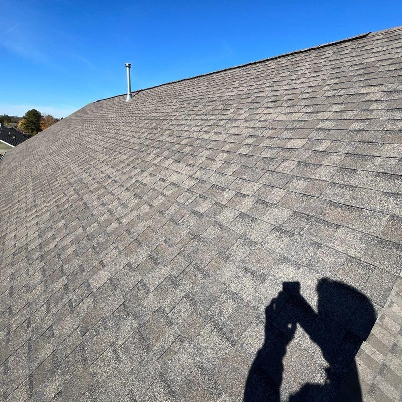 Asphalt shingle roof with hail damage inspection