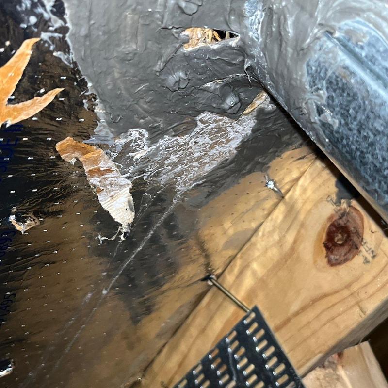Roof flashing with puncture and nail in wood framing