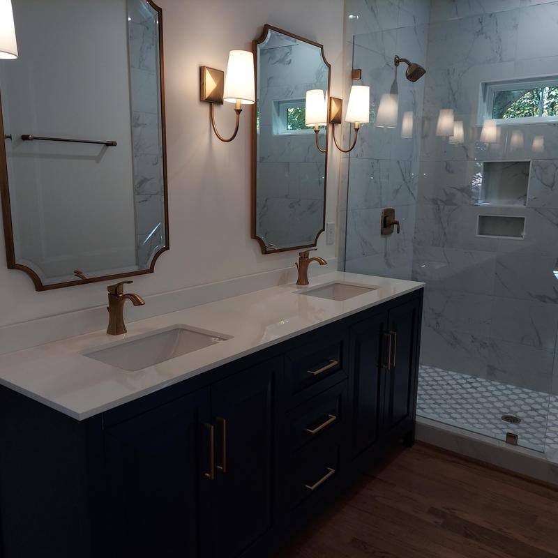 Double vanity with faucets and mirrors in modern bathroom Double vanity with faucets and mirrors in modern bathroom