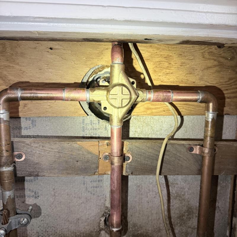 Shower valve and copper pipe plumbing system in basement Shower valve and copper pipe plumbing system in basement