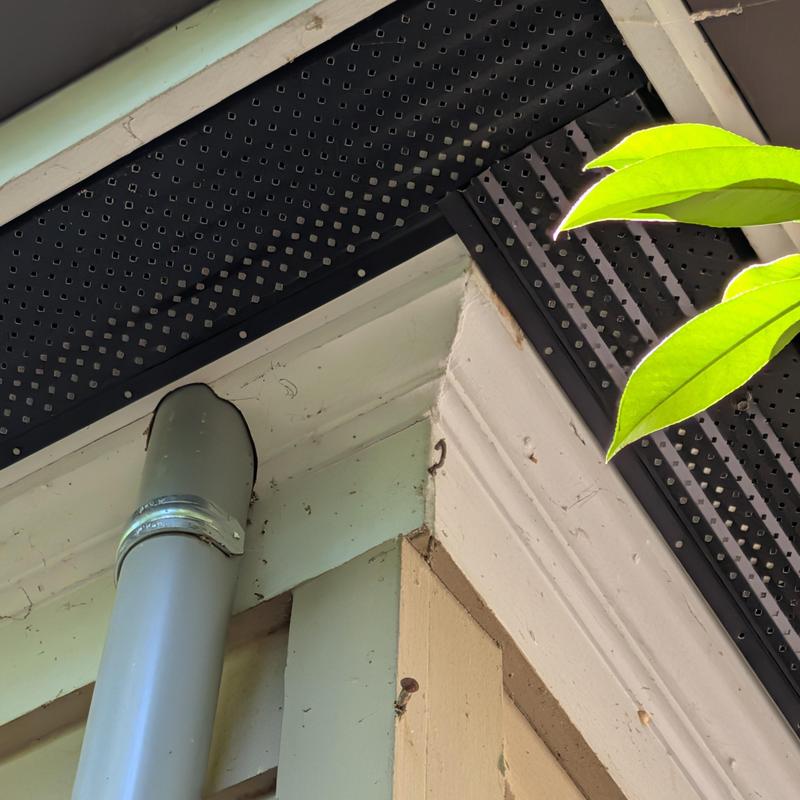 Soffit vent with squirrel damage repair on house corner