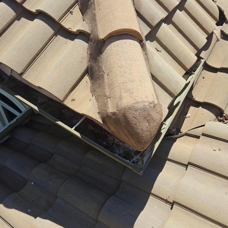 Concrete tile roof ridge with metal flashing detail Concrete tile roof ridge with metal flashing detail