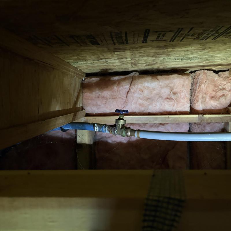 Water shutoff valve and pipes in garage ceiling cavity