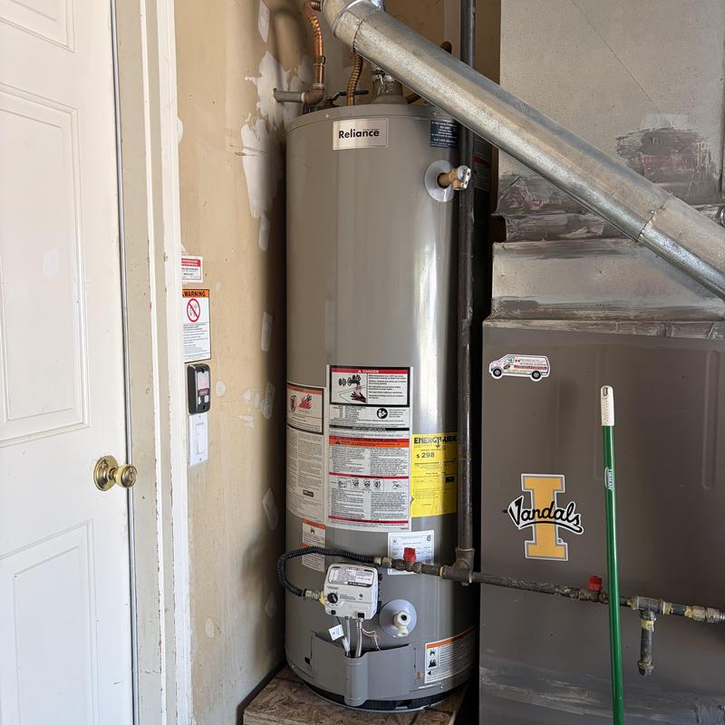 Water heater and furnace in garage with vent pipe