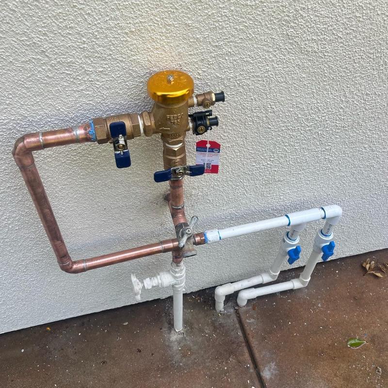 Pressure backflow valve with copper and PVC piping installation