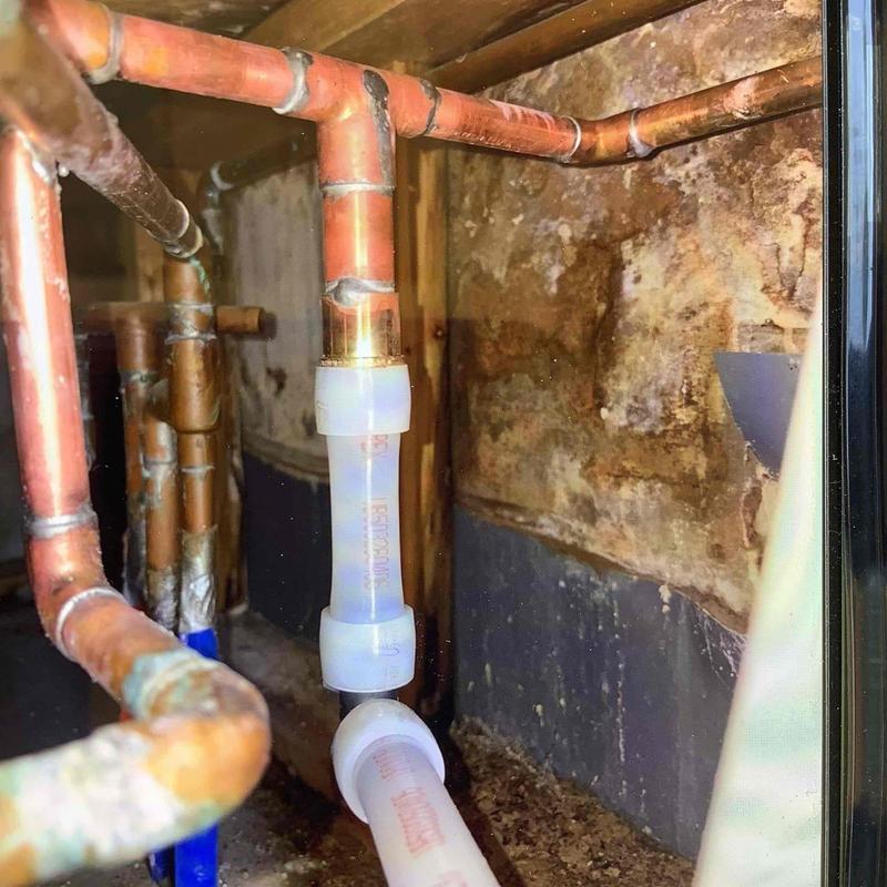 Copper manifold with PEX pipe connections in attic