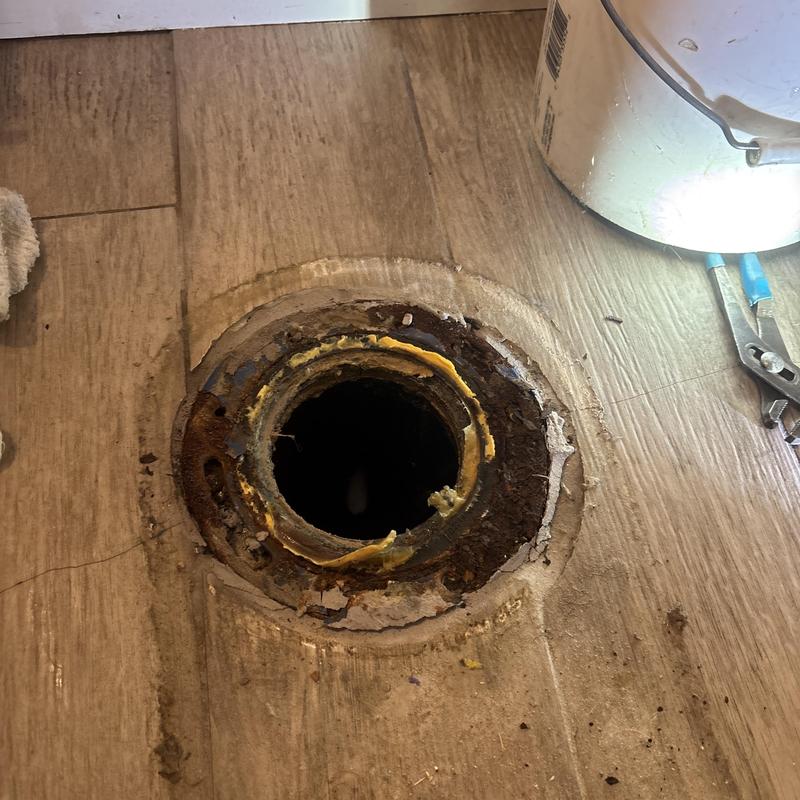 Toilet flange with rust and sealant residue Toilet flange with rust and sealant residue