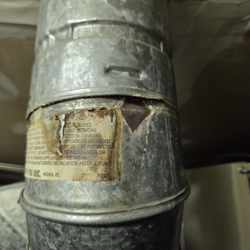 Furnace vent pipe rust and corrosion damage close-up