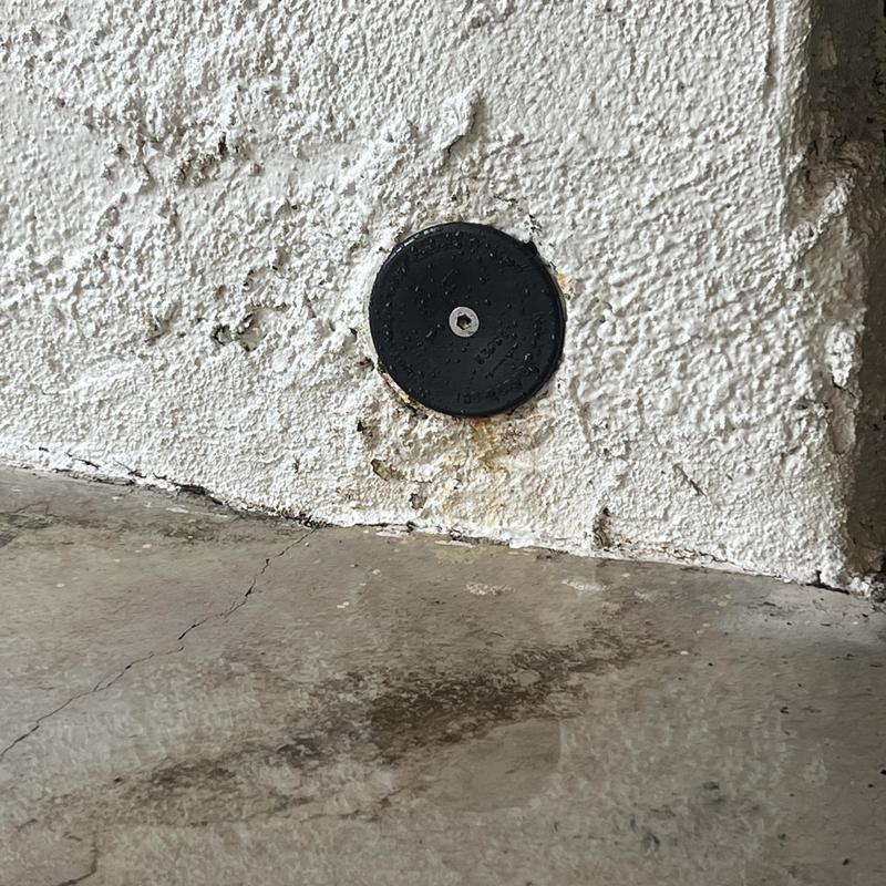 Clean out plug installation on stucco wall near floor Clean out plug installation on stucco wall near floor
