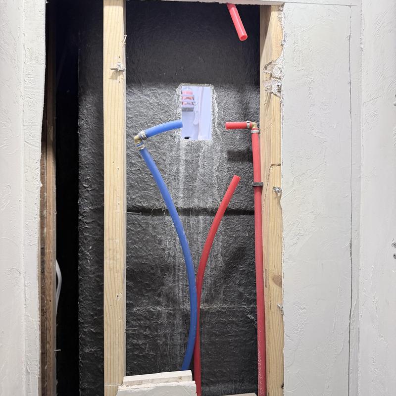 Shower valve piping with blue and red water lines installation Shower valve piping with blue and red water lines installation