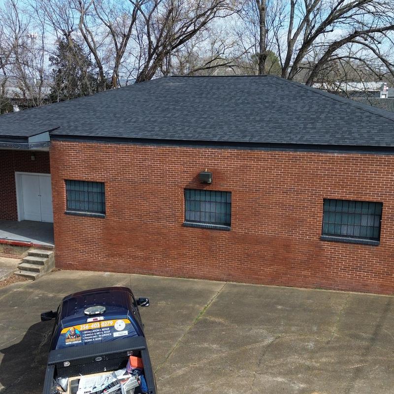 Commercial asphalt shingle roof on brick building