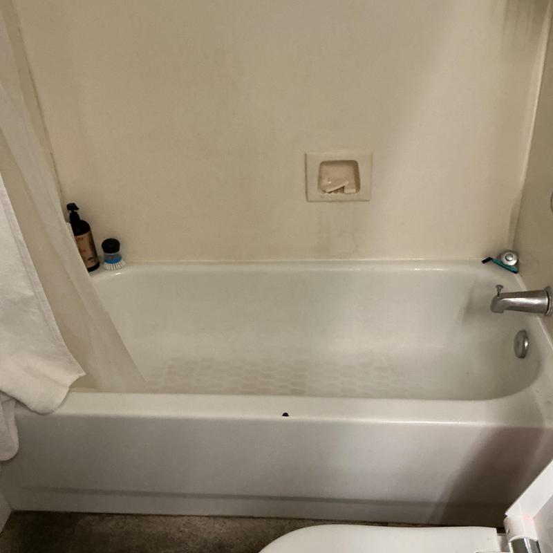Bathtub with faucet and soap holder in bathroom Bathtub with faucet and soap holder in bathroom