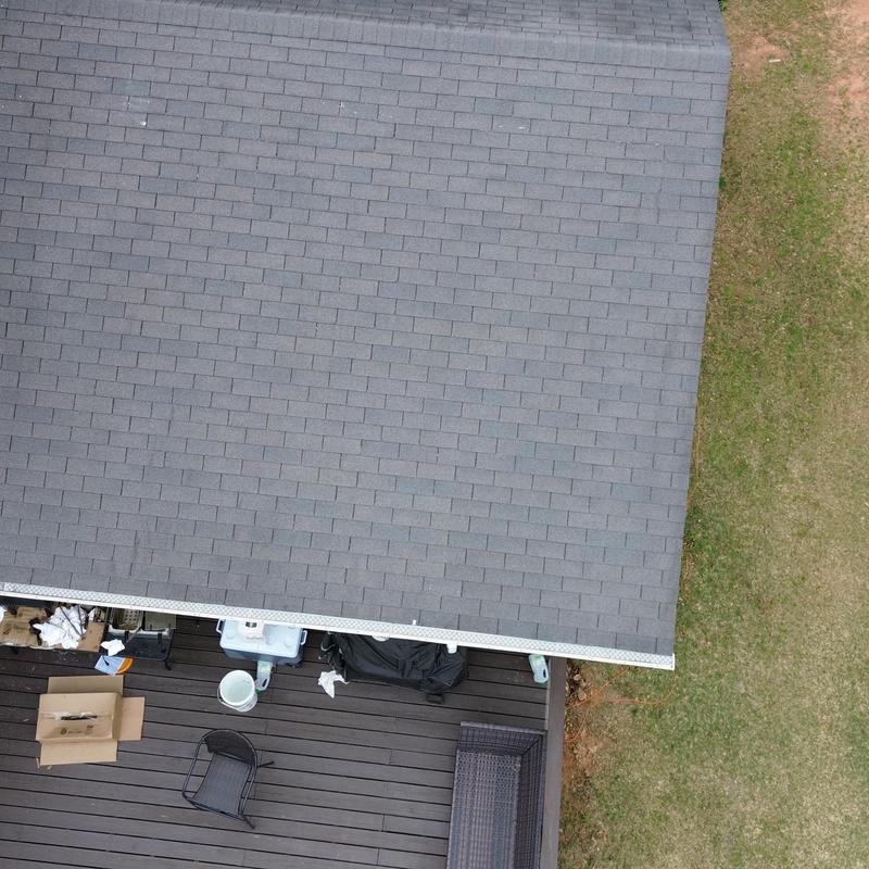 New gray asphalt shingle roof over deck