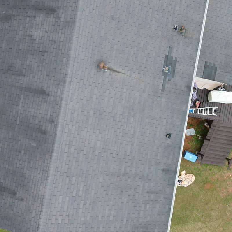 Asphalt shingle roof with multiple vent pipes and repairs