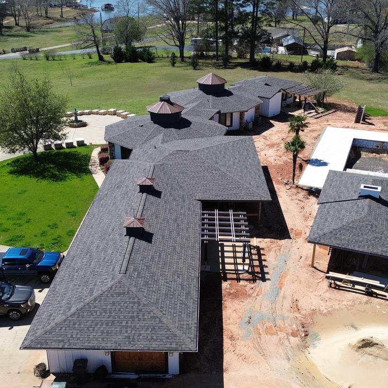 Architectural shingle roofing with cupolas on large home