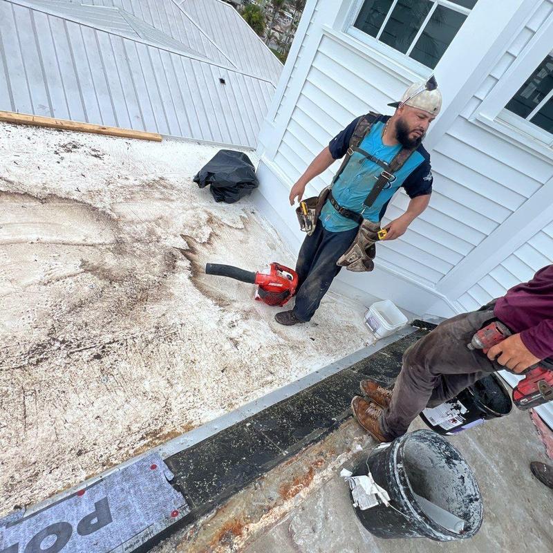 Flat roof membrane removal near house wall Flat roof membrane removal near house wall